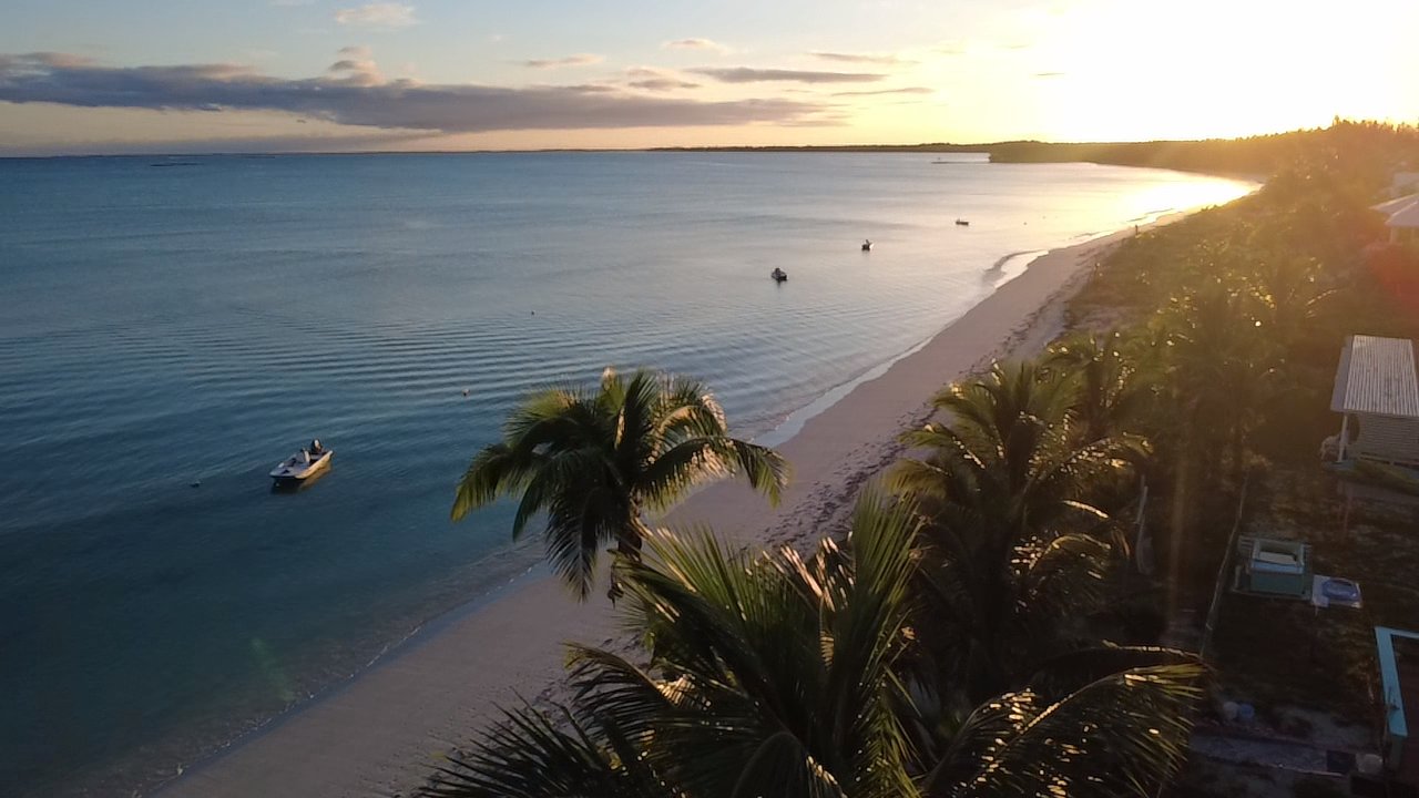 Aerial view of Casuarina Point beach at sunset