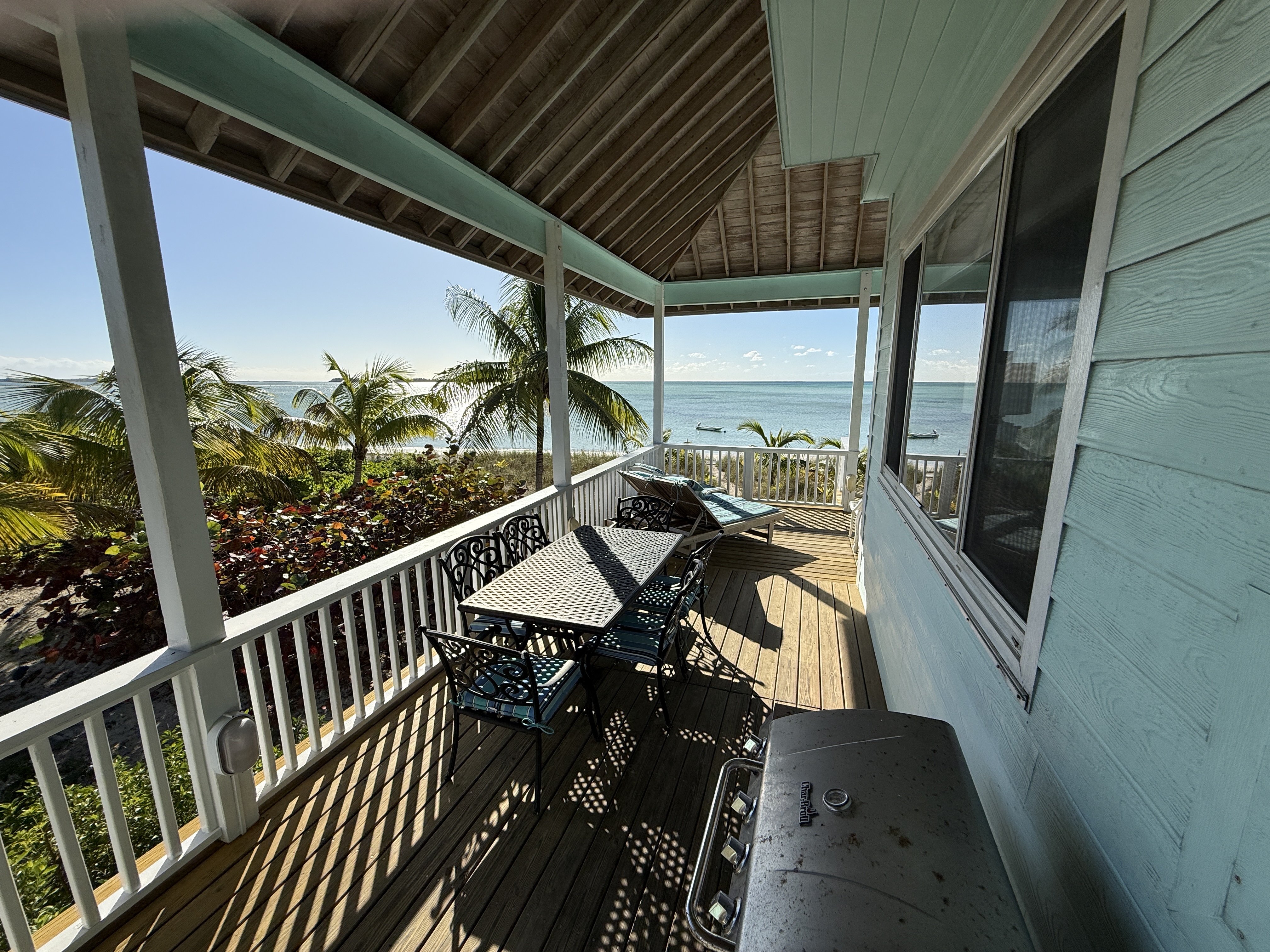 Deck stairs leading to the gas grill and dining table for 6