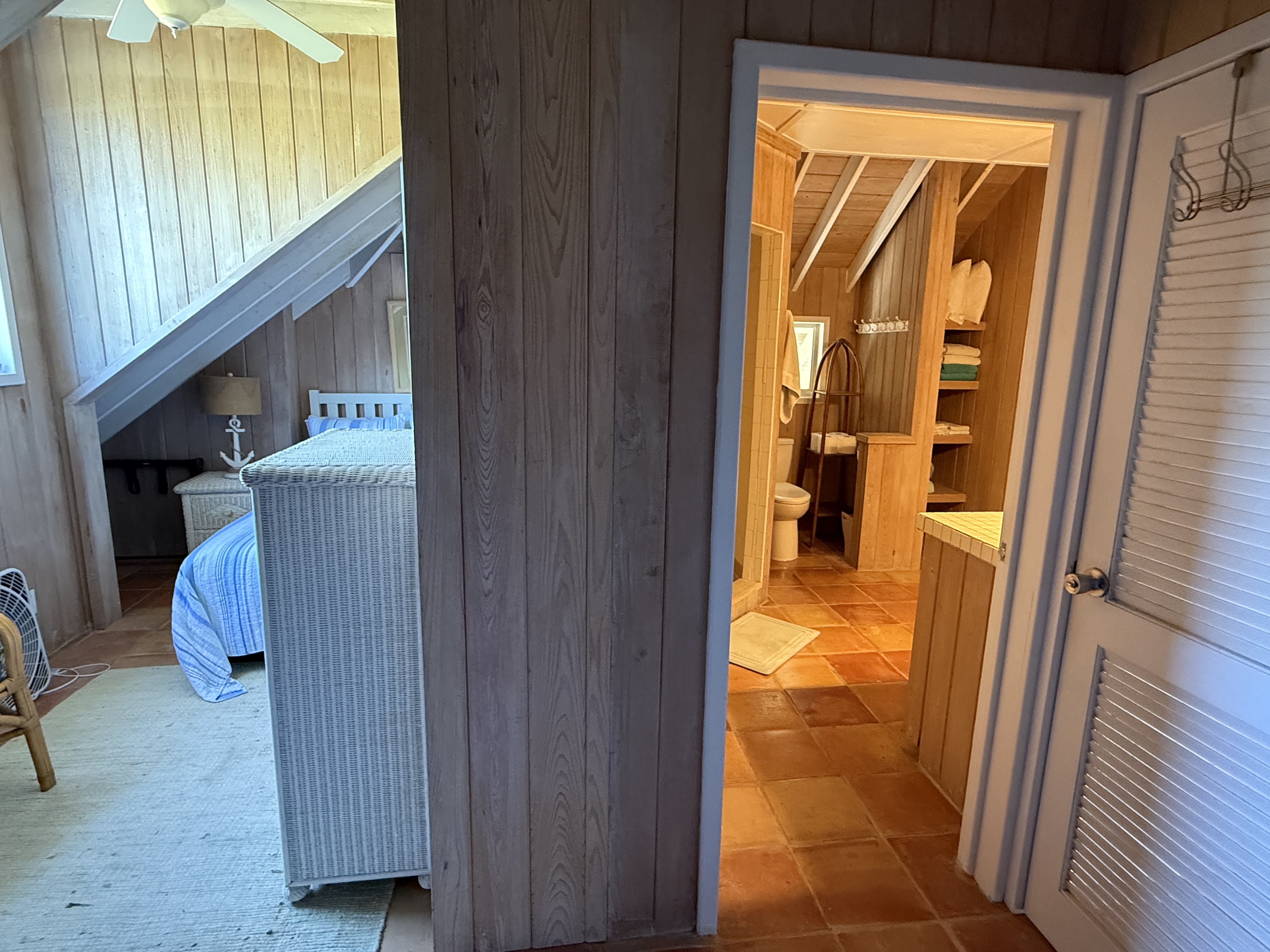 Just outside the bedroom with the 2 full beds is the door to the top floor bathroom.