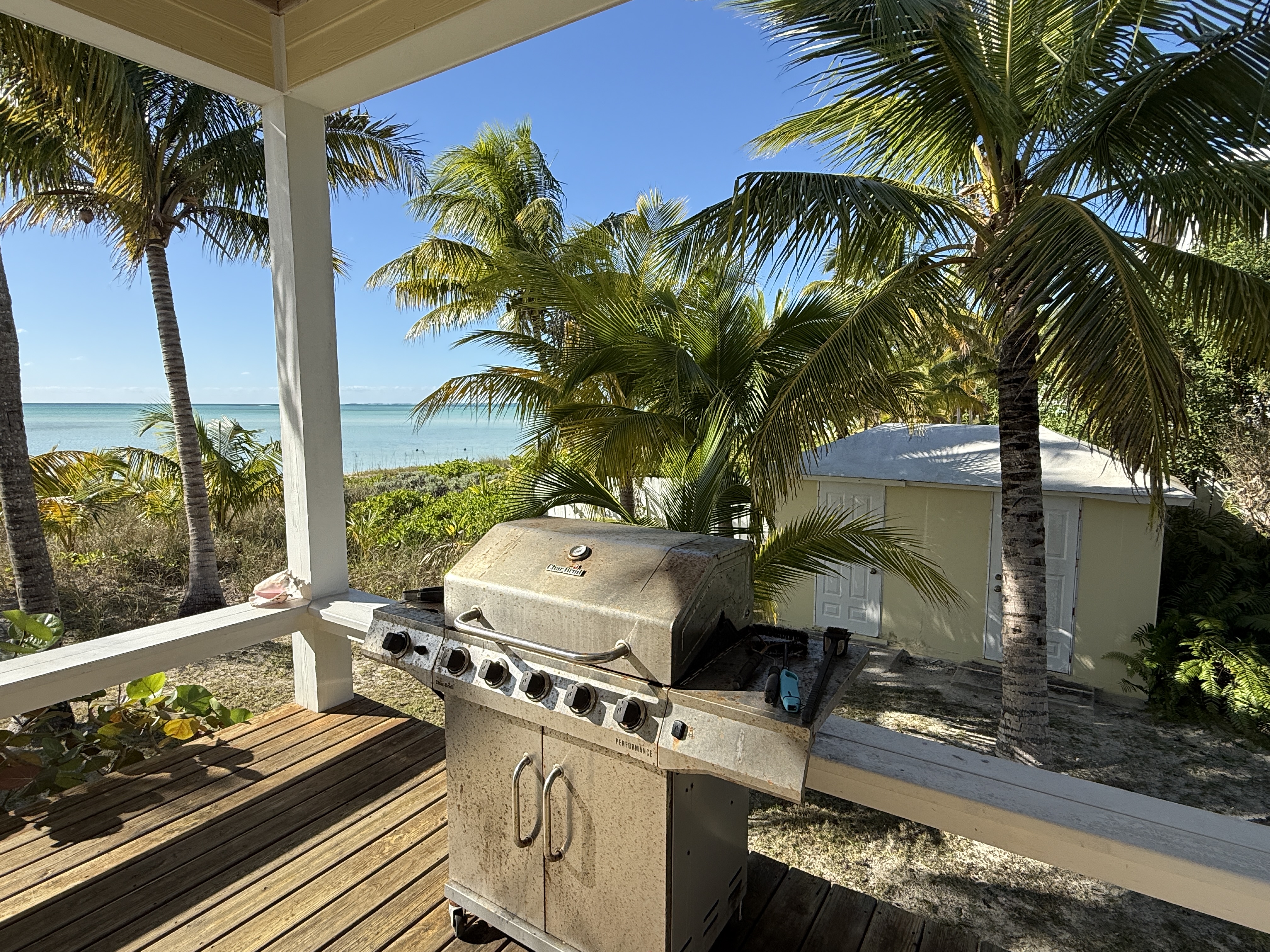 Covered deck with gas grill and ocean panorama