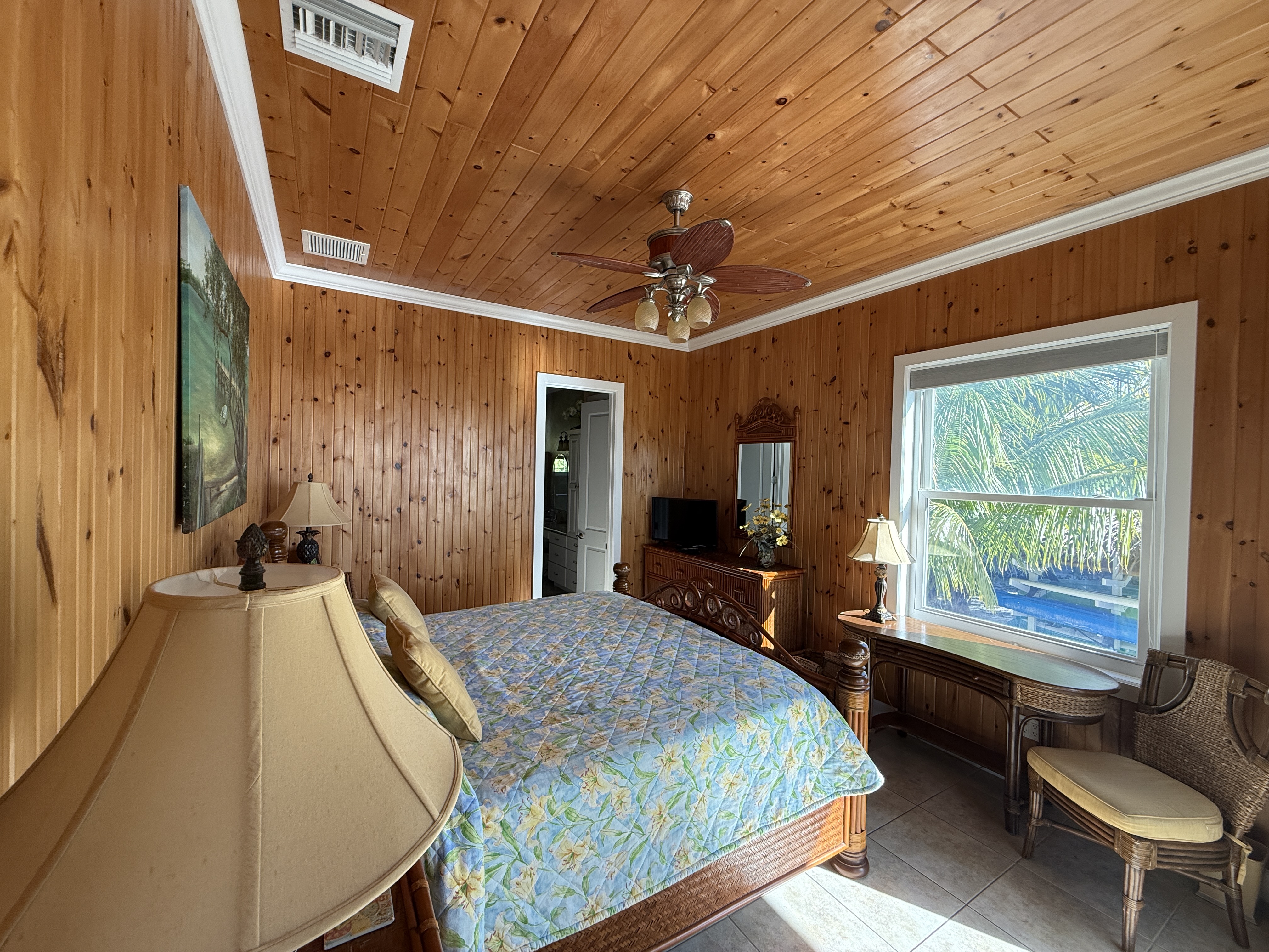 East Master Suite king bed with desk workspace ocean views