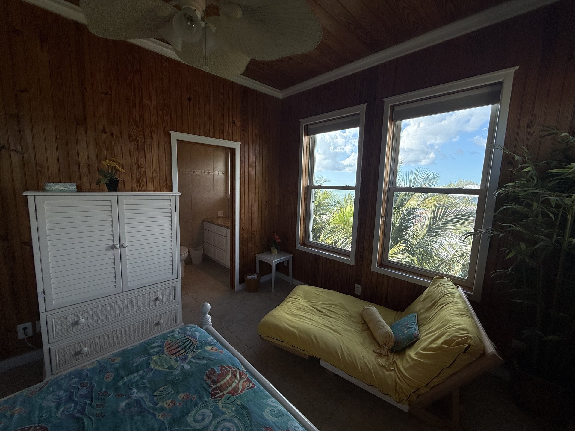 Queen bedroom upstairs with twin futon and ocean views