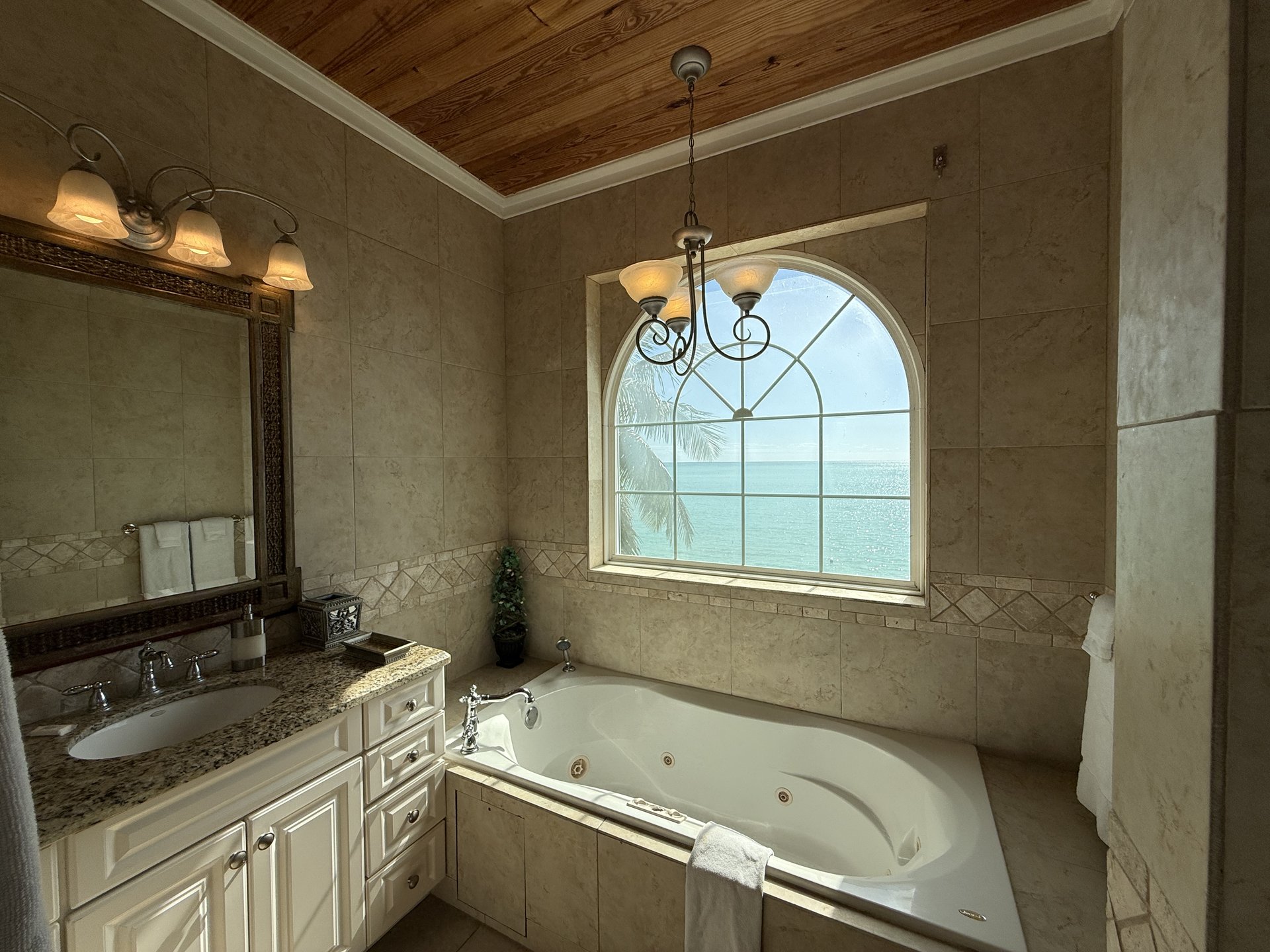 East Master Suite en-suite with large tub and an ocean view