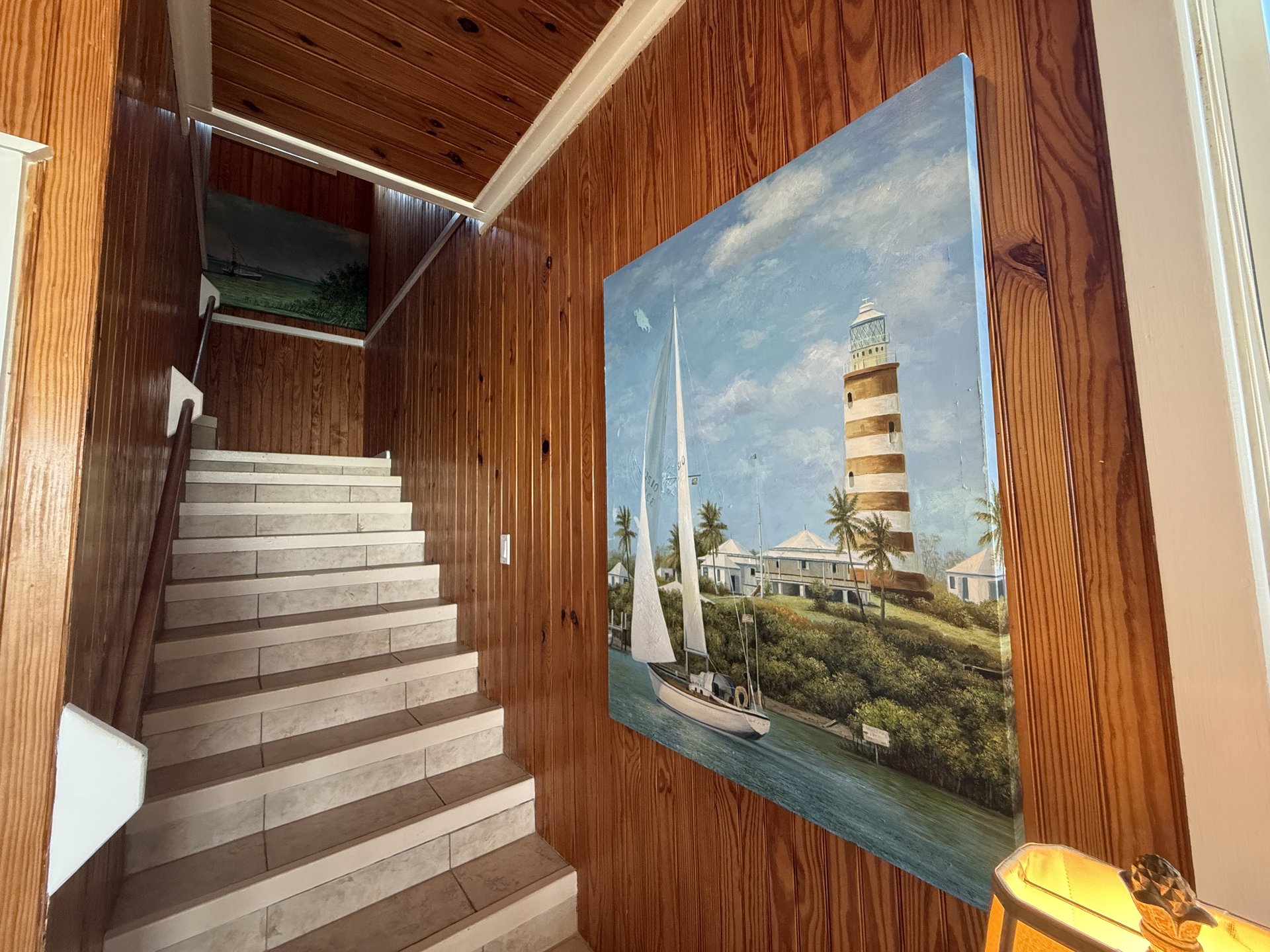 Stairway with Hope Town lighthouse painting