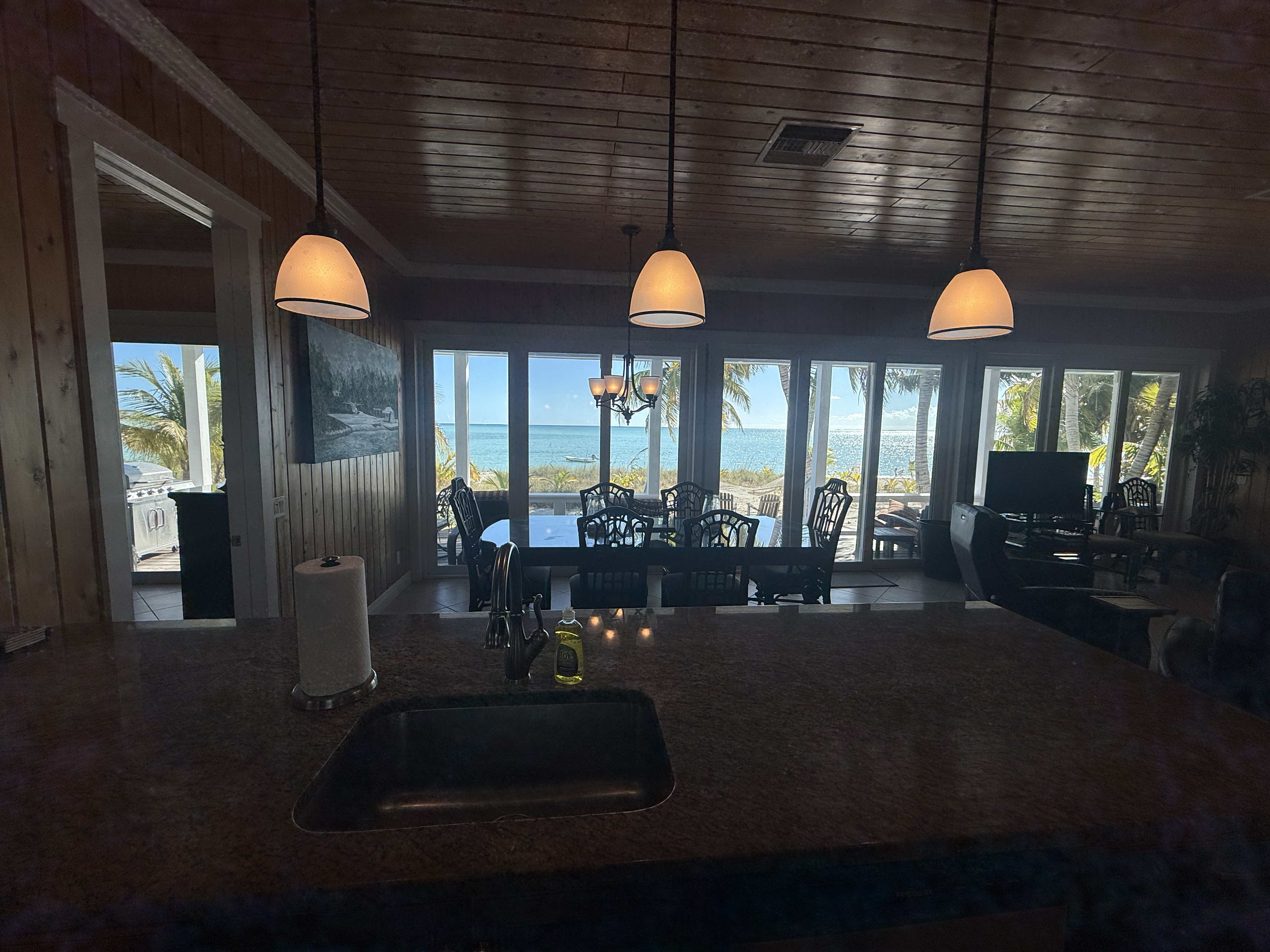 Kitchen view to dining and living with ocean beyond - making doing dishes a pleasure