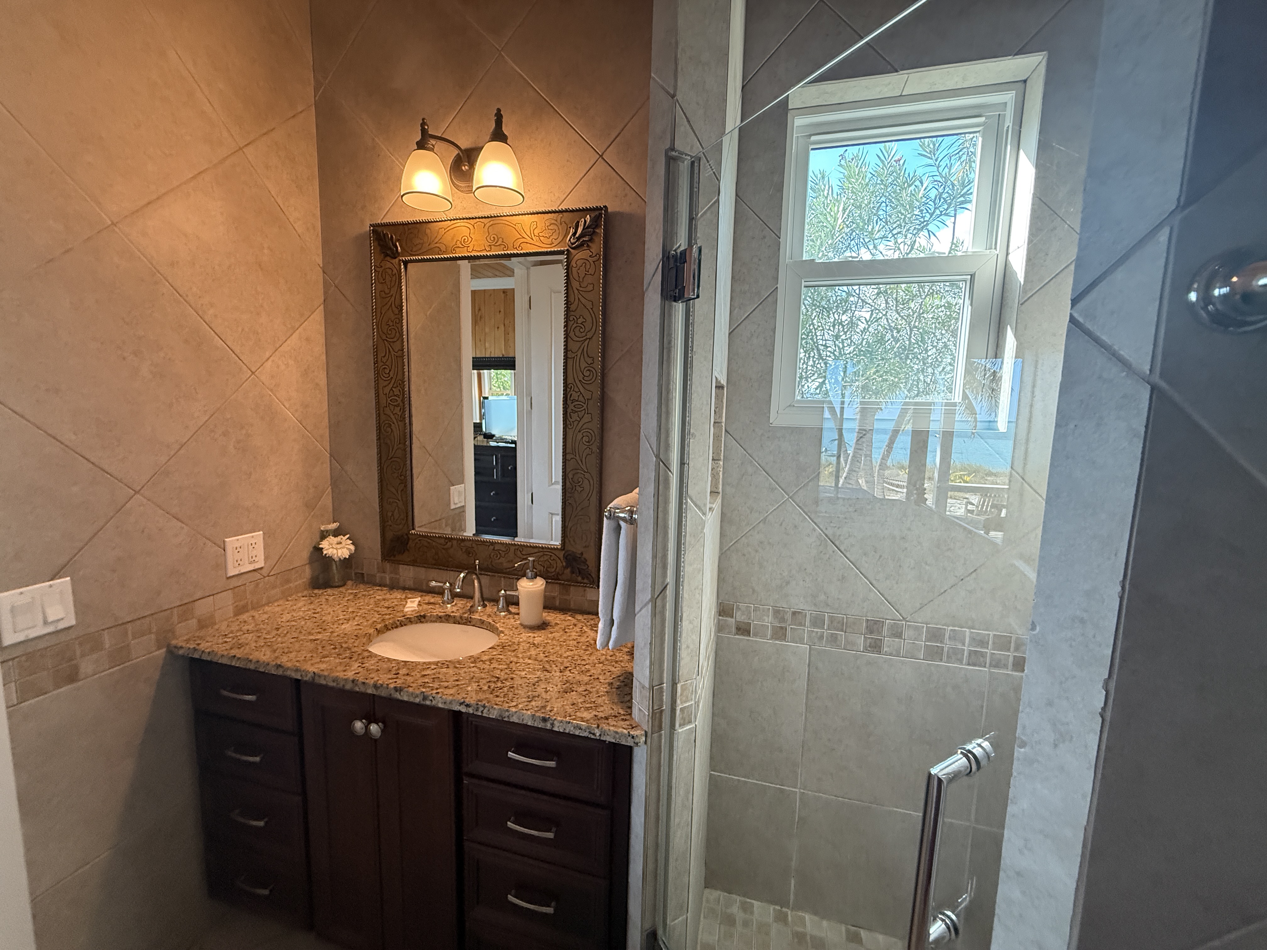 West Master bathroom vanity with shower with a window