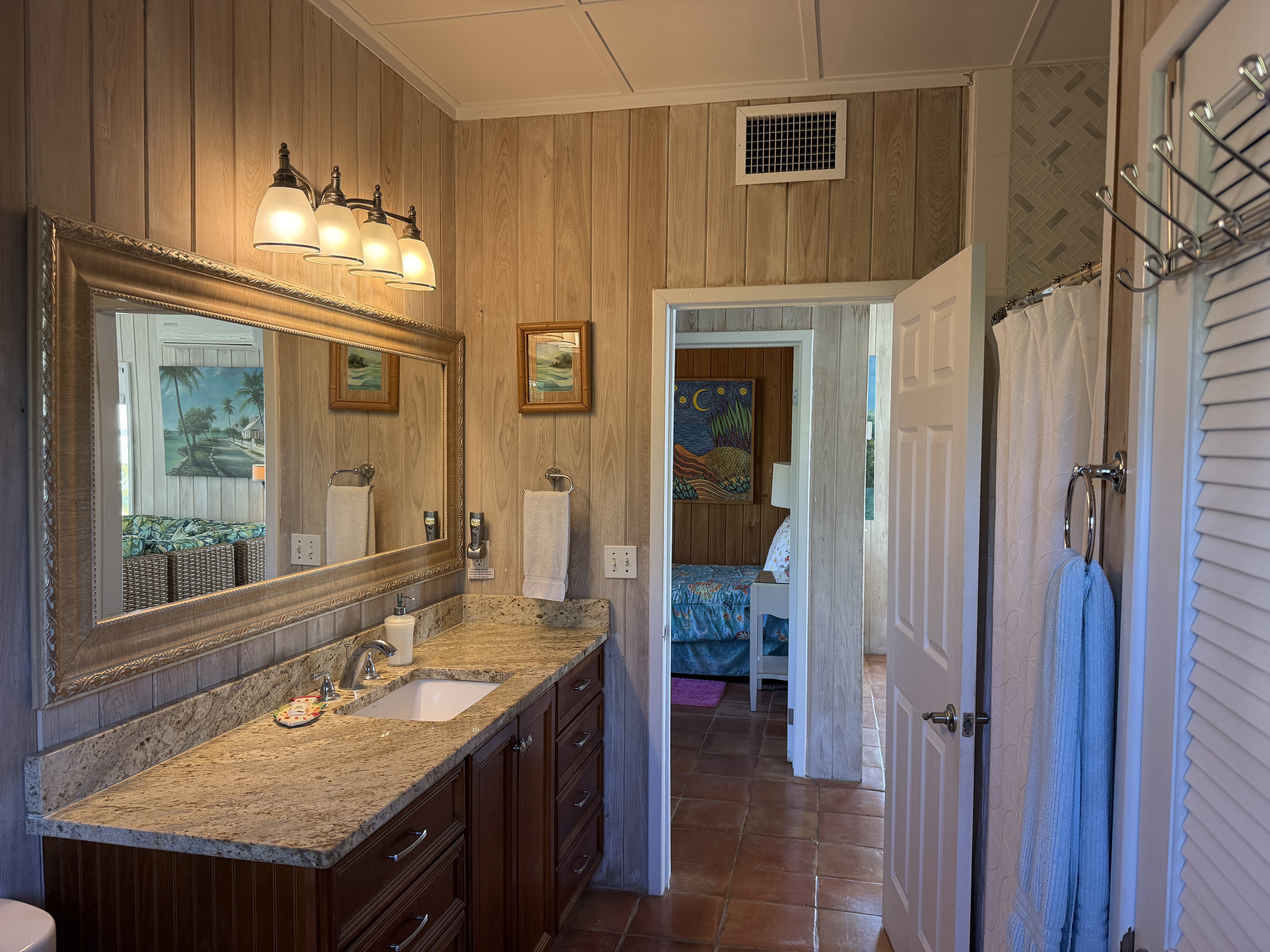 Main Floor Bathroom with large granite vanity and tub/shower - across from the twin bedroom and next to the main floor queen