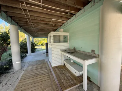 Under-house fish cleaning station and outdoor shower - viewed from the beachside