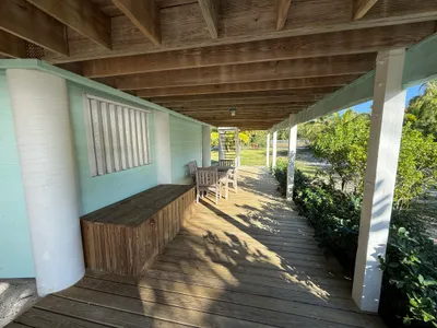 Under-house covered area with storage and seating