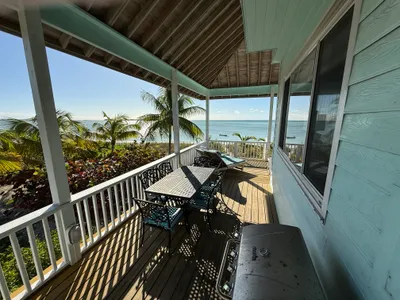 Deck stairs leading to the gas grill and dining table for 6