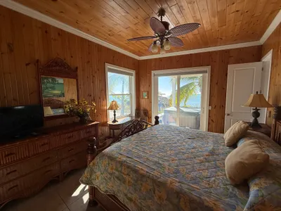 East Master Suite king bed with ocean views and deck access