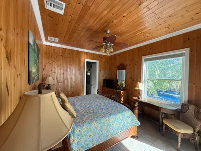 East Master Suite king bed with desk workspace ocean views