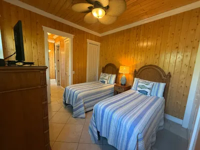 Guest bedroom with twin beds is tucked away in the back hall - a quiet space
