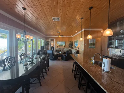 Open floor plan showing dining, kitchen counter, and living area