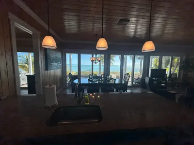 Kitchen view to dining and living with ocean beyond - making doing dishes a pleasure